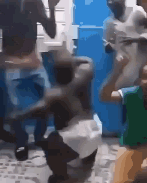 a group of people are dancing in a room with a blue wall behind them .