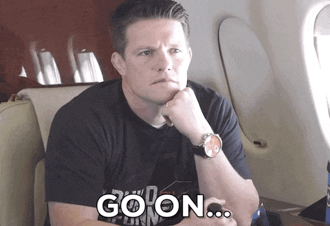 a man sitting on an airplane with the word goon written on the bottom
