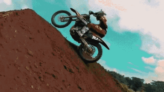 a person on a dirt bike with the number 10 on the back