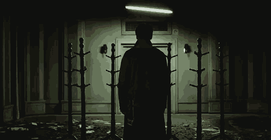 a man in a hooded sweatshirt is standing next to a woman .