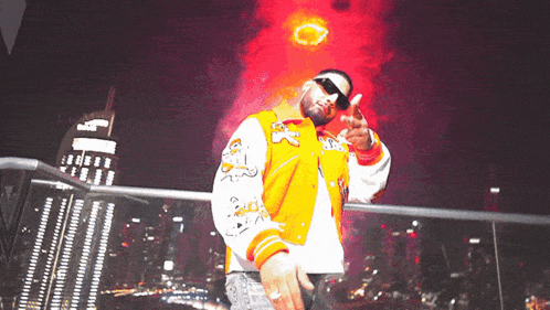 a man wearing an orange and white varsity jacket with the letter s on it