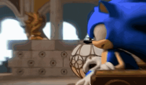 a blurry picture of sonic the hedgehog with a statue in the background