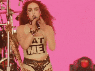 a woman with red hair is holding a microphone
