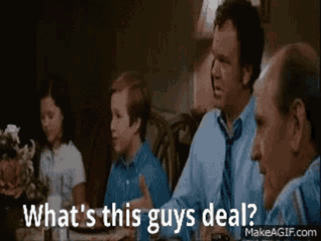 a group of people are sitting at a table and talking to each other .