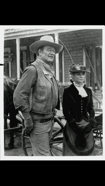 a man in a cowboy hat is standing next to a woman