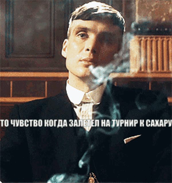 a man in a suit and tie smoking a cigarette with a caption in a foreign language