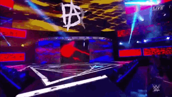 a stage with a wrestling logo on it and the words live on the bottom