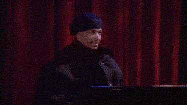 a man playing a saxophone and another man playing a piano