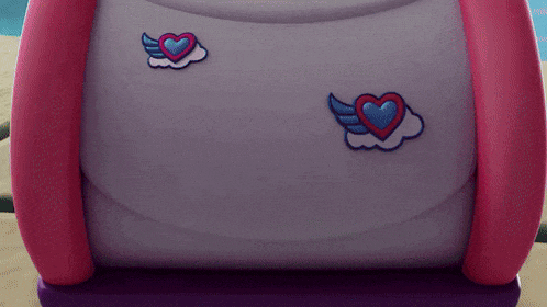 two hearts with wings are embroidered on the back of a purse .