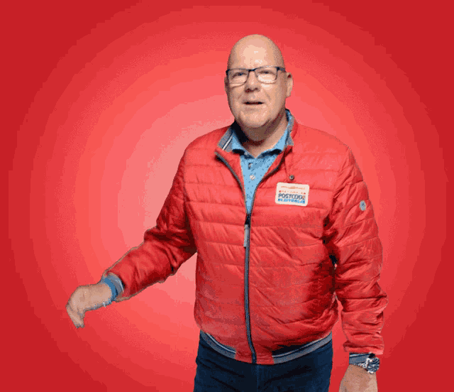 a man in a red jacket has a sticker on his jacket that says ' volkswagen '