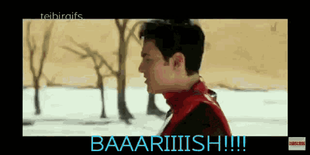 a man in a red jacket is standing in the snow and says baaaariiiish