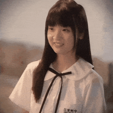 a girl wearing a white shirt with a black bow and a name tag that says jiangsu