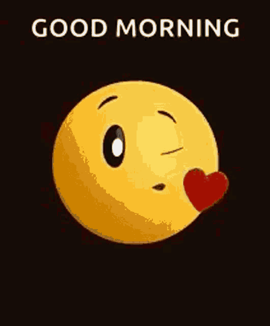 a yellow smiley face is blowing a kiss with a red heart on its nose .