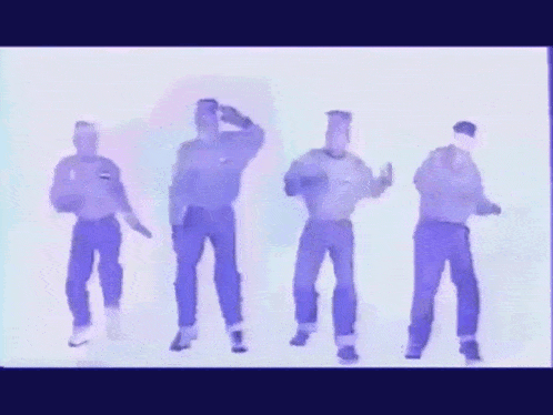 a group of men are dancing in a line with one wearing a purple shirt that says ' tommy jeans ' on it