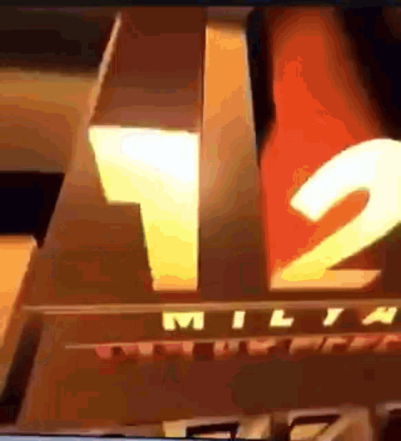 a close up of a milwaukee 12 logo on a tv screen