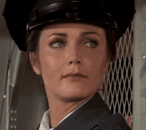 a close up of a woman 's face with a hat on