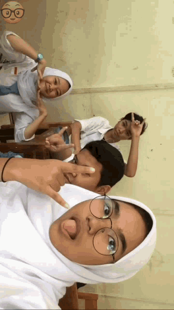 a group of people are posing for a picture and one of them is wearing glasses