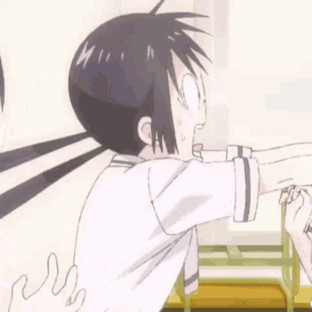a boy and a girl are standing next to each other in a room and the girl is holding the boy 's arm .