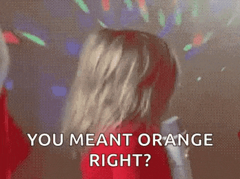 a woman in a red dress is dancing in front of a disco ball and says `` you meant orange right '' .