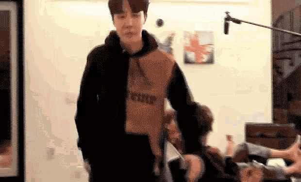 a pixelated image of a man wearing a hoodie that says ' puma ' on it