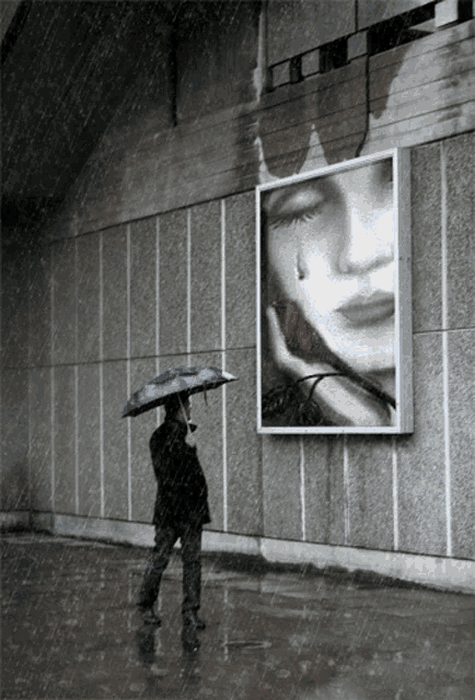 a man holding an umbrella in front of a picture of a woman with a rose