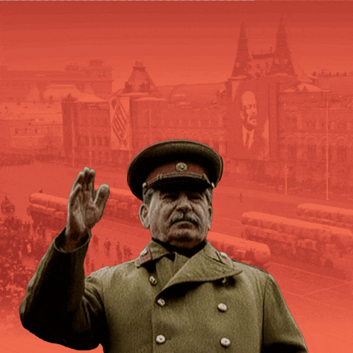 a man in a military uniform is waving his hand in front of a large banner with a picture of lenin on it