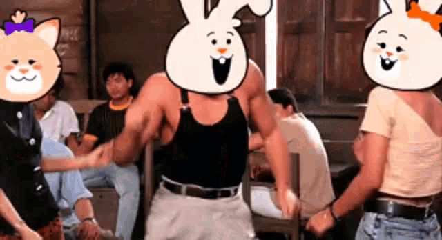 a group of people are dancing in a room with a cartoon cat and a cartoon rabbit on their faces .