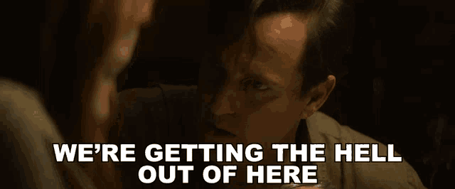 a man talking to a woman with the words " we 're getting the hell out of here " below him