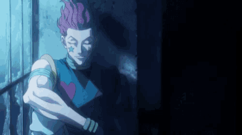 a man with pink hair and a star on his face is standing in a dark room