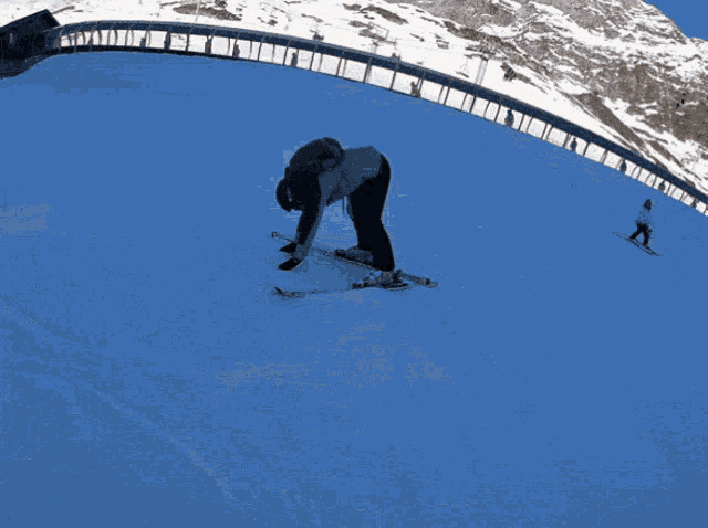 a group of people skiing down a snowy mountain