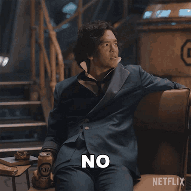 a man in a suit is sitting on a chair with the words of course not written below him