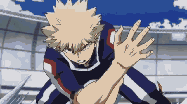 a man in a blue and white uniform is reaching out his hand towards something .