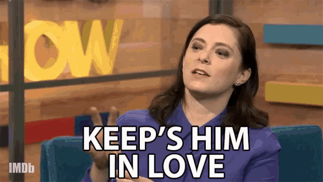 a woman says keep 's him in love while sitting on a blue chair