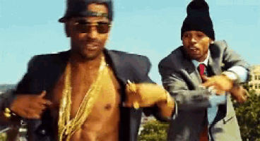 a shirtless man is standing next to another man in a suit and tie