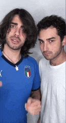 two men are standing next to each other and one is wearing a blue puma jersey