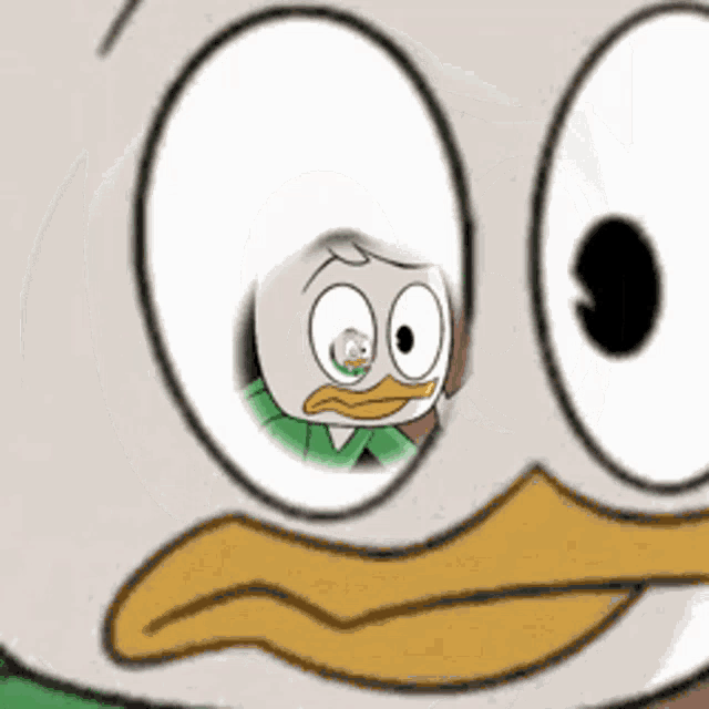 a close up of a cartoon duck 's eyes with a reflection of a person in them