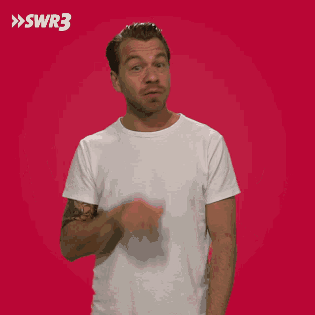 a man in a white t-shirt is making a funny face in front of a red background that says swr3