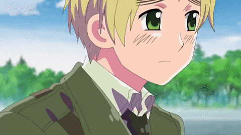 a boy with blonde hair and green eyes is wearing a green jacket and tie