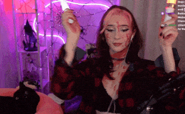 a woman in a plaid shirt with blood on her face is playing a video game