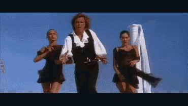 a man in a white shirt is dancing with two women