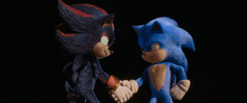 two cartoon characters are shaking hands in front of a light beam .