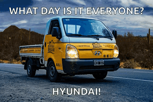 a hyundai truck is driving down the road