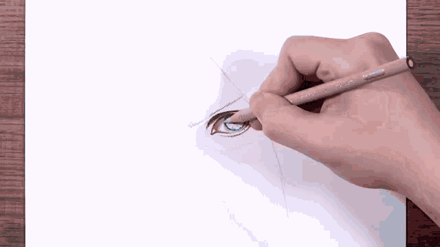 a person is drawing a woman 's eye with a pencil .