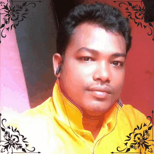a man wearing a yellow shirt and ear buds takes a selfie