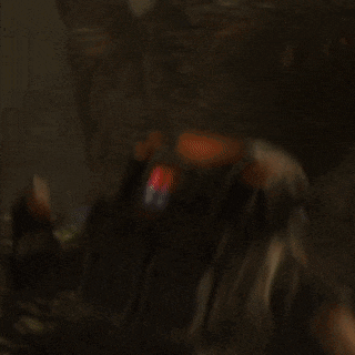 a blurred image of a person holding a gun with the number 1 on the back