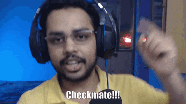 a man wearing headphones says checkmate in front of a blue background