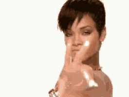 a woman with long nails is pointing at the camera .