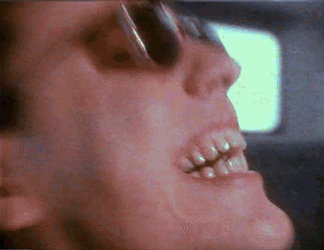 a close up of a person 's mouth with a few teeth visible