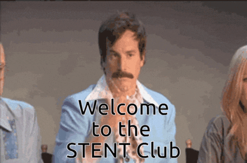 a man in a blue suit is sitting in front of a sign that says " welcome to the stent club "