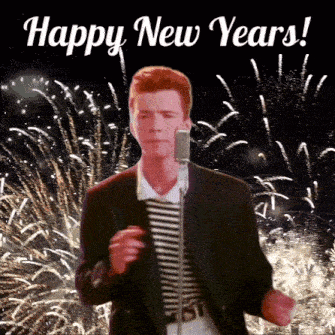 a man singing into a microphone with fireworks in the background and the words happy new years written above him
